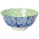 Bowl with blue and white floral pattern on one side and green and white geometric leaf pattern on the inside.