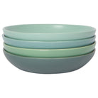 Set of four green ceramic bowls stacked on a white background