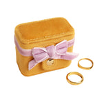 Mustard Velvet Ring Box jewelry box with a purple bow and gold rings 