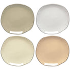 Four round ceramic side plates in beige, white, and brown on a white background