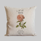 Decorative pillow with a vintage pink rose botanical design.