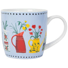 Mug with floral and gardening-themed design on a light blue background